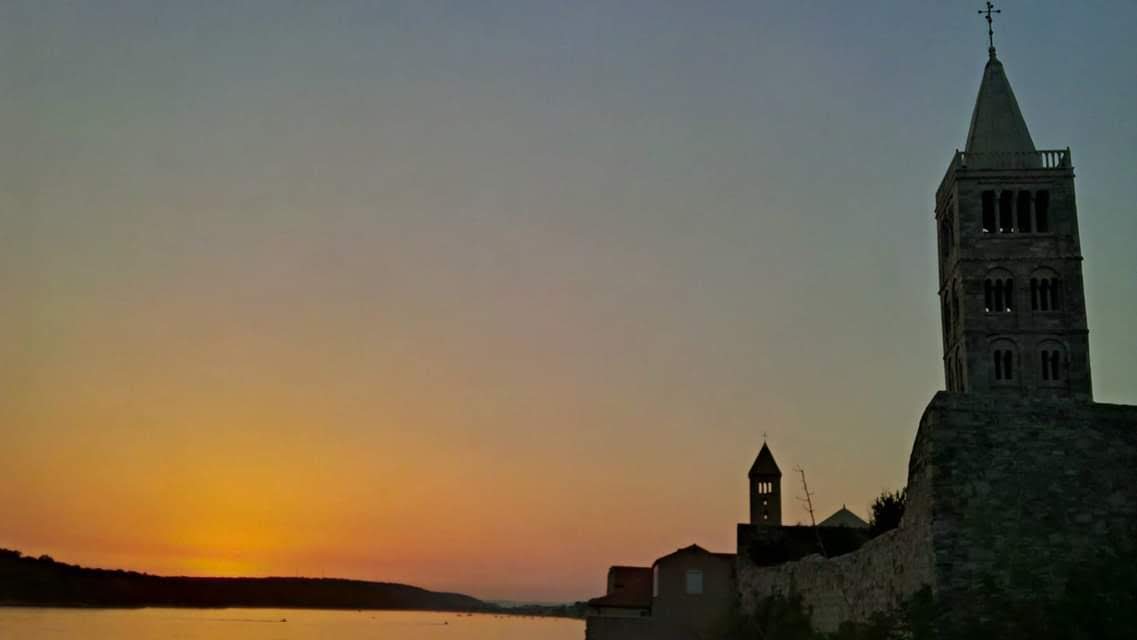Sunset silhouette of a bell tower along the Croatian coast