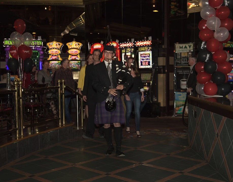 Sean Rathwell piping in the head table for the grand opening of Mactavish's on Argyll