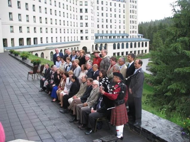 Sean Rathwell piping at the Chief Electoral Officers' Conference in Lake Louise, Alberta, with Canada's Chief Electoral Officer and provincial and territorial CEOs