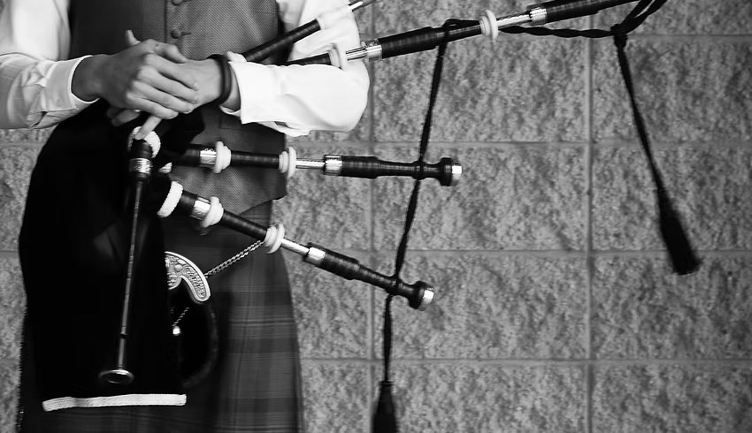 Close-up detail of bagpipes and traditional Highland dress, black and white