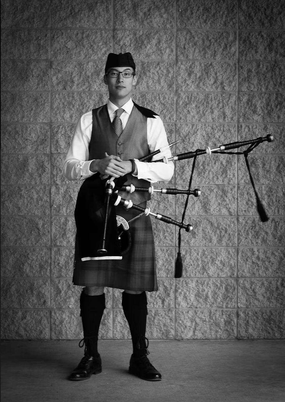 Solo formal portrait of Sean Rathwell in traditional Highland dress